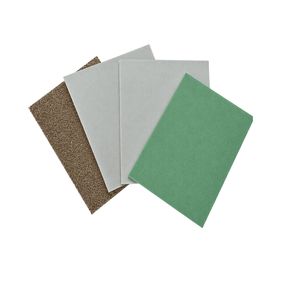 Three rectangular sanding or polishing sheets in brown, light gray, and green, arranged in a fan shape on a plain white background.