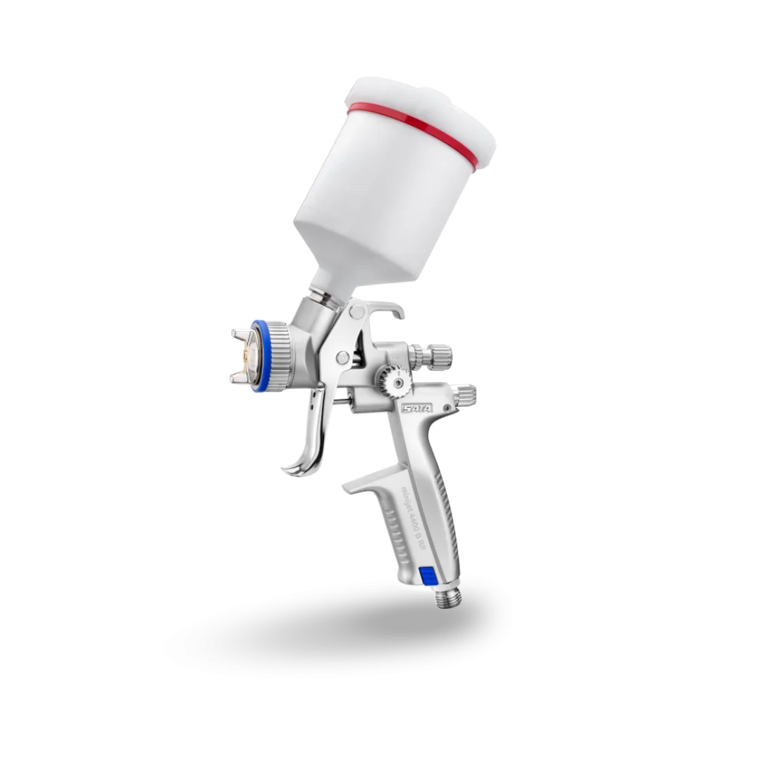 Spray gun with white cup and silver body on a white background