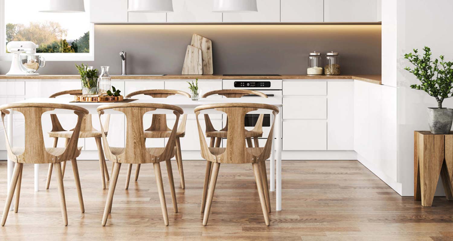 White unit kitchen with natural wood effect furniture and flooring